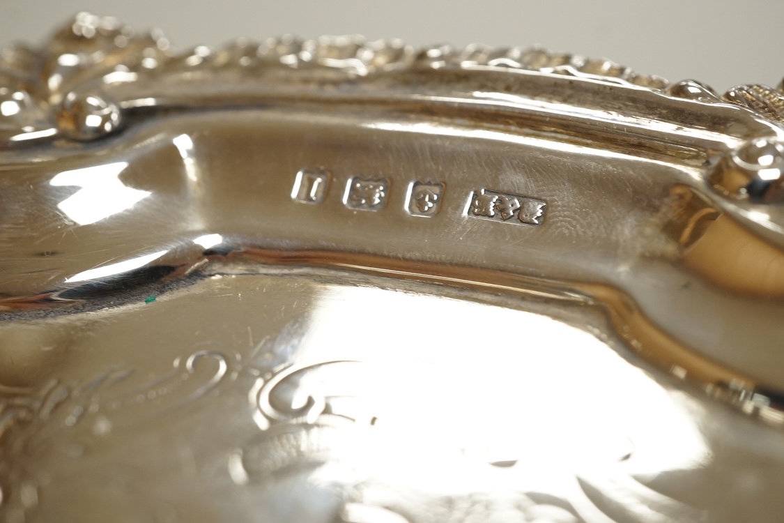 A George V silver waiter, with engraved crest and shell and scroll border, Deykin & Harrison, Birmingham, 1910, 21.5cm, 8.9oz.